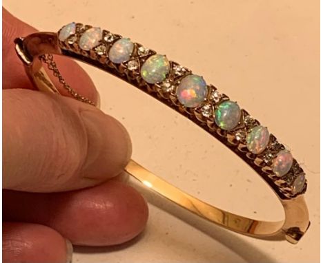 UNHALLMARKED BANGLE SET WITH TWO OPALS APPROX 0.1ct, TWO APPROX 0.3ct, TWO APPROX 0.4ct, TWO APPROX 0.5ct, ONE 0.75ct, SIXTEE