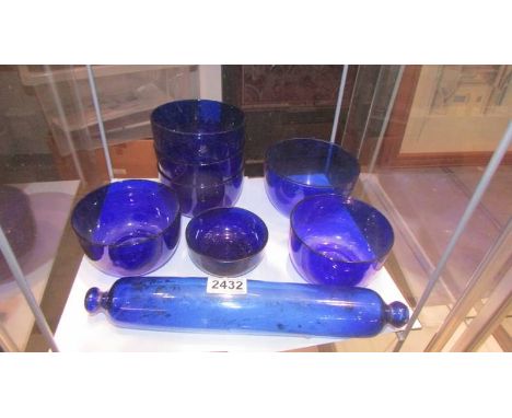 A Bristol blue glass rolling pin and seven blue glass bowls. (Collect only)