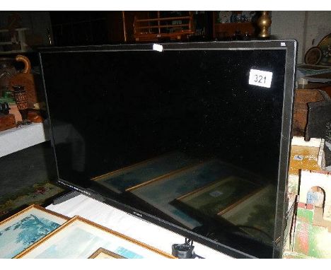 A Polaroid flat screen TV with remote. (collect only)