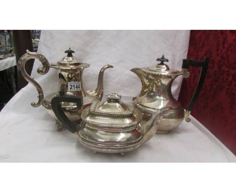 Two silver plate coffee pots and a silver plate teapot.