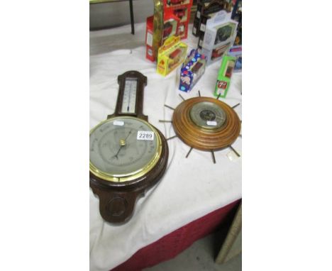 An oak barometer/thermometer in good condition together with another barometer (cracked glass)