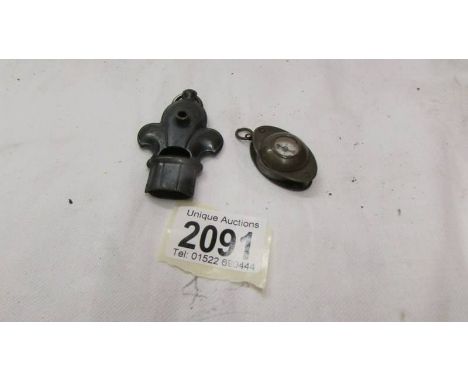 An old 'Fleur de Lys' shaped whistle and an old compass incorporating magnifying glass.