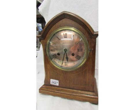 A mahogany inlaid 8 day mantel clock. (Collect only)