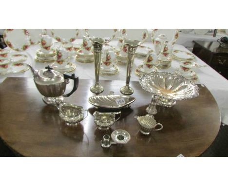 A mixed lot of silver plate including teapot, spill vases, etc.,