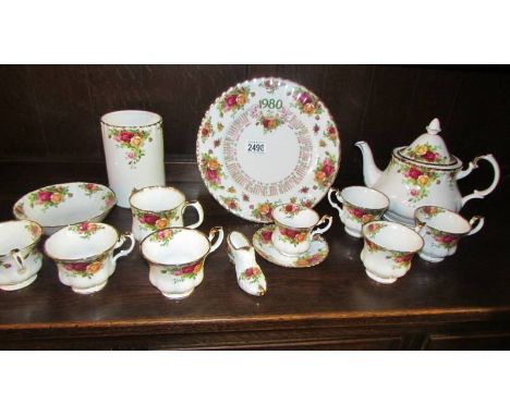 Six Royal Albert old country roses tea cups, a teapot, a coffee cup with saucers, utensil jar etc.,