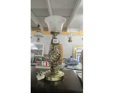 A metal table lamp with glass shade.