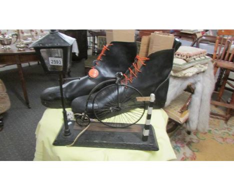 A massive pair of oversized boots and a table lamp featuring a street lamp and a penny farthing (Boots possible to Otley clow