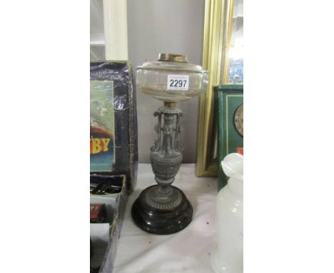 An oil lamp base with glass font.