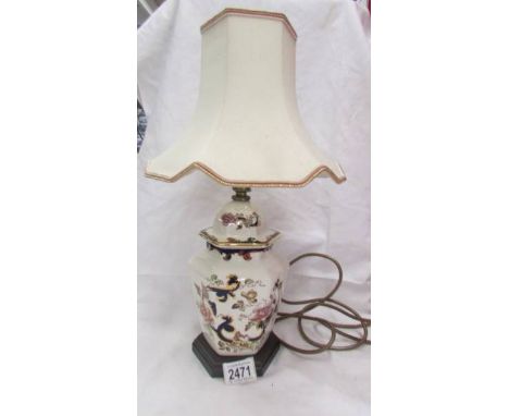 An oriental style table lamp with shade.