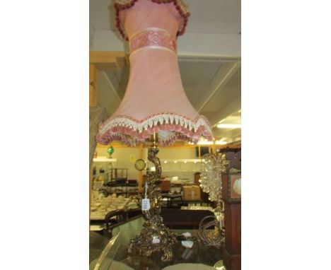 A heavy brass table lamp with cherub to base and with good quality fringed shade. (Collect only)