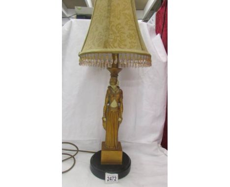 An art deco style figural table lamp with shade.