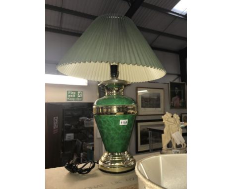 A green and gilded table lamp with shade