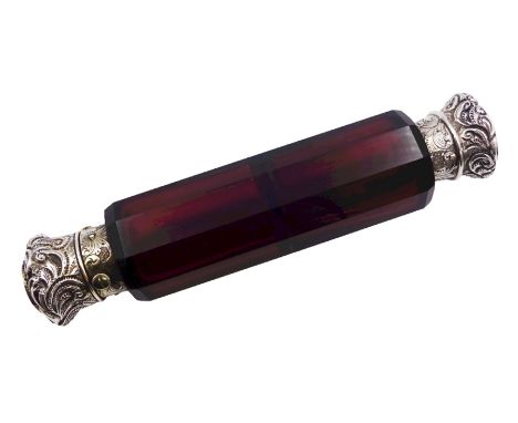 Victorian double ended ruby glass scent bottle, the faceted body with silver foliate detailed hinged cover to one end, and co