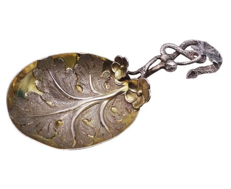 Unusual Victorian silver caddy spoon, the oval parcel gilt bowl embossed with leaf, leading to a flower head mounted tendril 