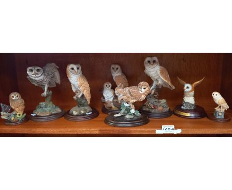 A collection of unglazed ceramic owl ornaments