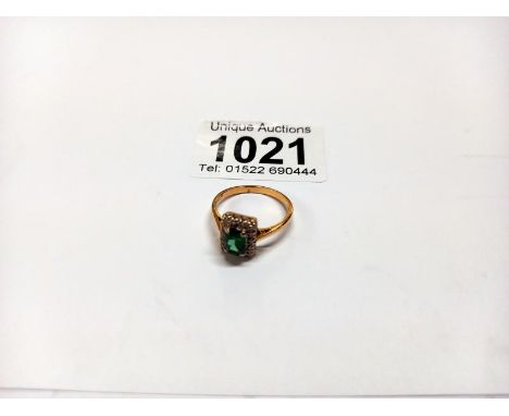 An 18ct gold green stone ring, size M half, 3.5 grams.