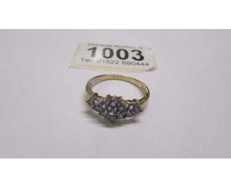 A yellow gold fifteen stone tanzanite ring size T half, 2.8 grams.