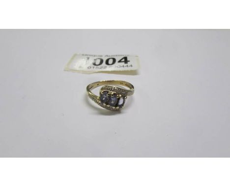 A 9ct gold three stone aqua ring with diamonds, size P, 2.5 grams.