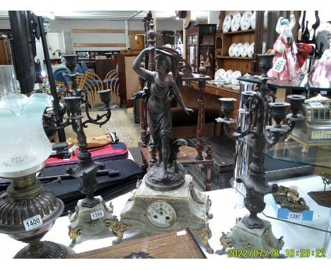 A Three piece clock garniture - The clock surmounted female figure and with enamel dial. COLLECT ONLY.(1 candelabra is damage