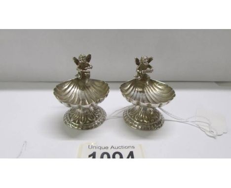 A pair of silver salts surmounted cherubs, Birmingham 1894/95.