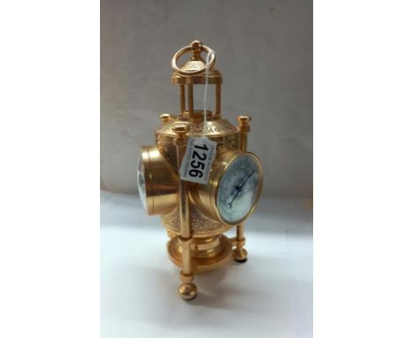 A gilded three faced clock/barometer/thermometer with compass in top (clock battery operated).