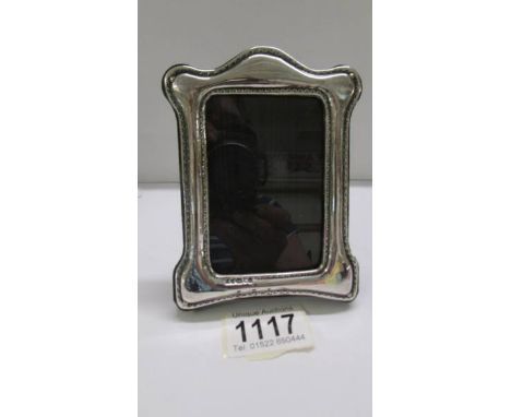 A small silver photo frame, 13 x 9 cm.