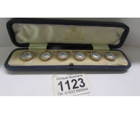 A cased set of six enamel buttons with 9ct gold rims.