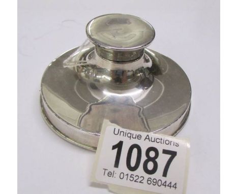 A silver inkwell.