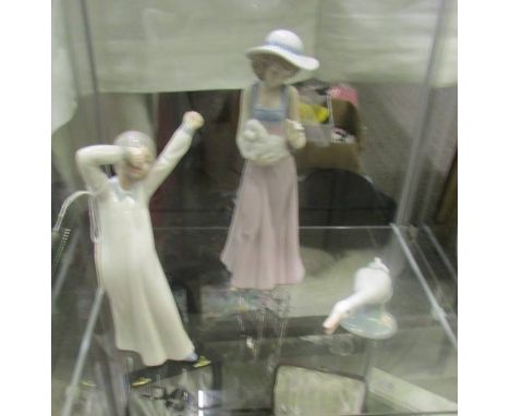 Two NAO figures and a Lladro goose.