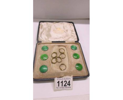 A cased set of 6 Mappin &amp; Webb George V silver and green enamel buttons.