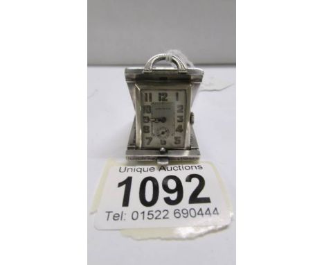 A Swiss miniature sterling silver travelling timepiece, the rectangular dial with Dauphin hands and subsidiary dial, stamped 