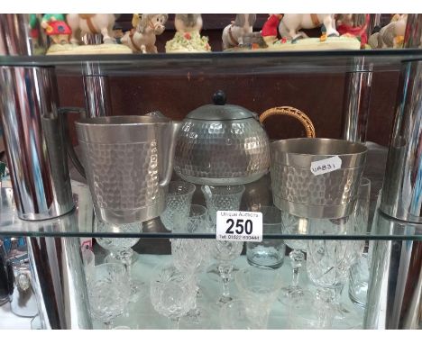 A pewter teapot, sugar bowl and jug