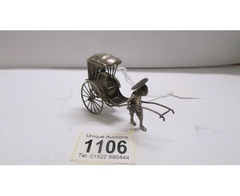 A silver oriental rickshaw.