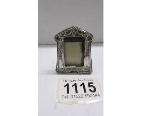 A miniature silver photo frame, 5 x 4 cm.