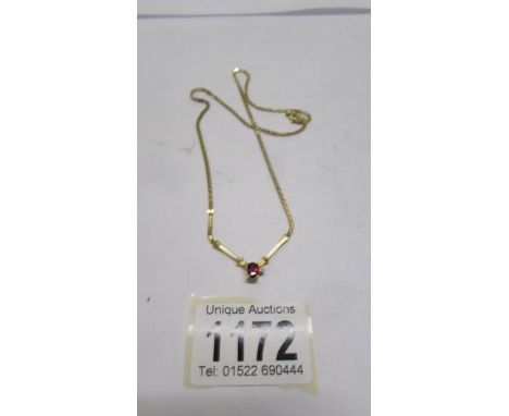 A ruby and diamond pendant with attached chain, stamped 10ct gold.