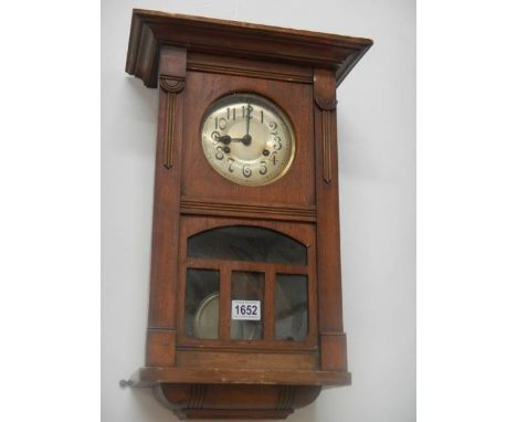 A 1930's oak wall clock. COLLECT ONLY.