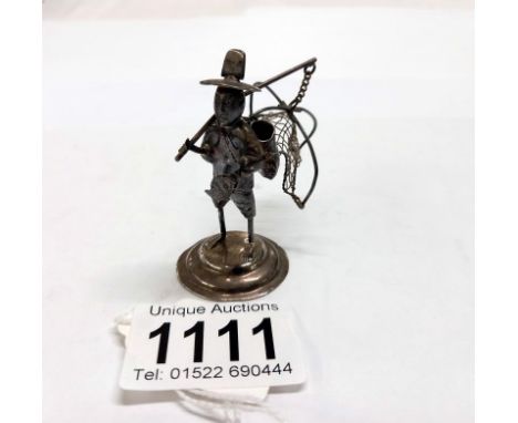 A miniature silver fisherman with basket.