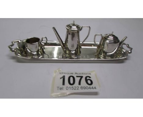 A small silver tray, coffee pot, teapot and sugar bowl, 66 grams.