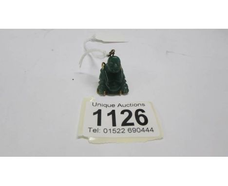 A jade Buddha pendant.