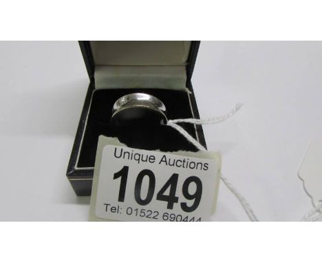 A white metal ring, size O.