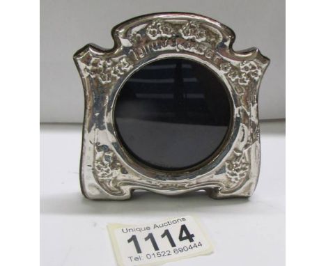 A small silver photo frame, 9 x 8 cm.