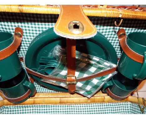 A wicker picnic hamper and contents 