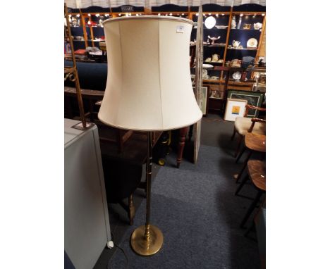 A brass standard lamp and shade 