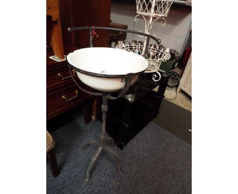 A shabby chic French enamel wash basin in a telescopic base