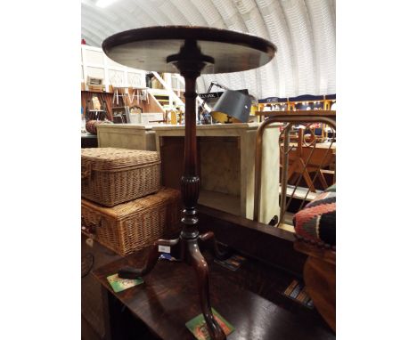 A circular mahogany wine table on tripod base