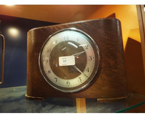 A mid-20thC oak cased mantel clock with slot to top reading 'Two Florins Weekly'
