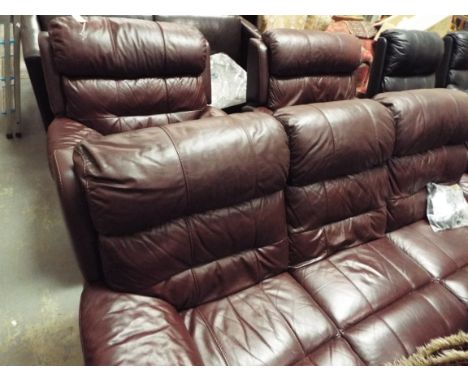 A Furniture Village 'Moreno' oxblood leather three seater reclining sofa and two matching reclining armchairs 