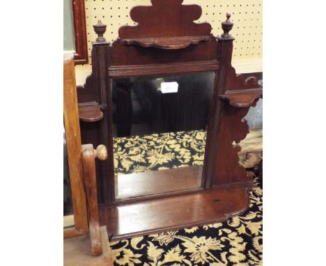 A mahogany framed shelf unit with central bevelled mirror and a mahogany corner shelf