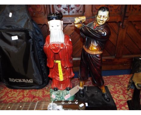 A ceramic figure of a Chinese deity together with a resin figure of a vintage golfer