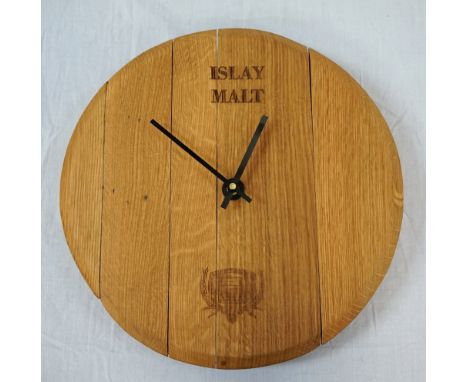OAK WALL CLOCK BY ALL THINGS WOODformed from the end of an Islay whisky barrel, 39.5cm diameterNote: All Things Wood create a
